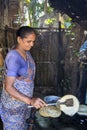 Indian woman preparing dosa at a kitchen, Auroville