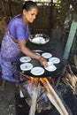 Indian woman preparing dosa at a kitchen, Auroville