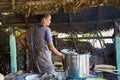 Indian woman preparing dosa at a kitchen, Auroville