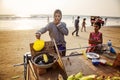 Indian woman preparing roasted sweet yellow corn at the beach