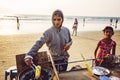 Indian woman preparing roasted sweet yellow corn at the beach