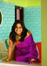 Indian Woman in Purple Saree Bending and Standing