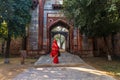 Indian woman in red sari near Arab Ki Sarai Gateway of Humayun's Tomb, New Dehli, India Royalty Free Stock Photo