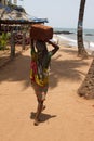 The Indian woman in a sari stones for building on the head on a beach. India Goa Royalty Free Stock Photo