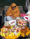 Indian woman selling pooja items in Varanasi, India