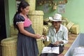 Indian woman sells wicker baskets to shopkeeper Royalty Free Stock Photo