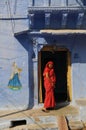 Indian woman smiling and standing in front of her house Royalty Free Stock Photo