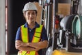 Indian woman staff worker engineer supervisor in safety suit work in factory warehouse