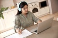 Indian woman student wear headphones watching online class seminar at home. Royalty Free Stock Photo