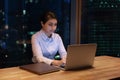 Indian woman texting on computer working until late in office Royalty Free Stock Photo