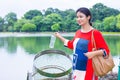 Indian woman throwing plastic bottle into dustbin, concept of environmental protection, littering of environmental Royalty Free Stock Photo