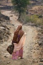 Indian woman walking down country lane