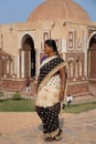 Indian woman walking near Alai gate, Qutub Minar, Delhi, India