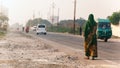 Indian woman walking on the road