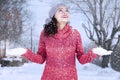 Indian woman with warm clothes playing snow