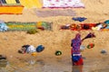 Indian woman washing colorful clothes