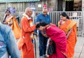 An Indian woman wearing a traditional sari taking the blessings of a monk in a saffron Royalty Free Stock Photo