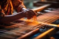 An Indian woman weaves a carpet on a loom. Hands close-up. Royalty Free Stock Photo