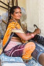 Indian woman weaving a hand made carpet in Jaipur