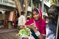 Indian women beggar or untouchables caste hold baby and begging money from travelers people in New Delhi, India