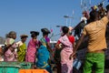 Indian women in bright dresses are waiting for the unloading of the fishing boat. India, Karnataka, 2017