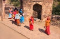 Indian women in colorful saris walking trhough the gate at Ranthambore Fort, India