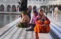 Indian women sitting near the lake at Golden Temple. Amritsar. India Royalty Free Stock Photo