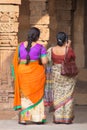 Indian women standing in courtyard of Quwwat-Ul-Islam mosque, Qutub Minar, Delhi, India