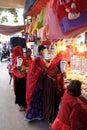 Indian women with traditional colored sari buy in the bazaar in Pushkar, I