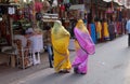 Indian women with traditional colored sari on the street of Pushkar