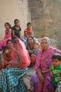 Indian women in traditional colorful saris and children