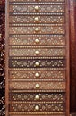 Indian wooden cabinet with drawers with golden inlay and round handles