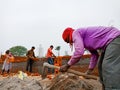 an indian worker holded spade for raw materials mixing task at home construction site in India dec 2019