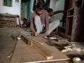 an indian worker making furniture at workshop, iron blade equipment aviable for wood chopping in factory in India January 2020 Royalty Free Stock Photo