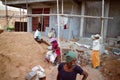 Indian Workers in construction of concrete houses near sand pile