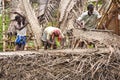 Indian workers covered the top of the log cabin with coconut leaves to serve tourists