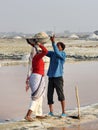 Indian workers putting basin with salt on head of woman on Sambhar Salt Lake. Rajasthan. India