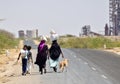 Indian workers walking past industries