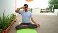 Indian young boy meditating at home. Portrait of Asian cute boy practicing yoga on home background. Worldwide yoga day concept