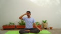 Indian young boy meditating at home. Portrait of Asian cute boy practicing yoga on home background. Worldwide yoga day concept