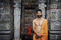 Indian Young brahmin stands near the temple of Krishna. July 17, 2013 in Naggar, Kullu Valley, Himachal