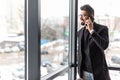 Indian young business man use phone in modern office Royalty Free Stock Photo