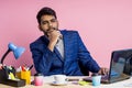 Indian young businessman sitting at workplace Royalty Free Stock Photo