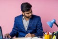 Indian young businessman sitting at workplace Royalty Free Stock Photo