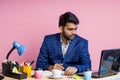 Indian young businessman sitting at workplace Royalty Free Stock Photo