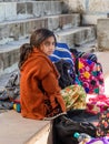 Indian young girl sitting with bags at Pushkar lake in Rajasthan. India Royalty Free Stock Photo