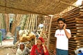 Indian young man talking on his mobile phone with his family members on the roadside of the Delhi.