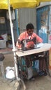 An Indian young man using sewing machine