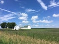 Indiana farm with green and white barn under a blue sky Royalty Free Stock Photo