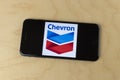 Chevron logo on a smartphone. Chevron traces its roots to the Standard Oil Corporation